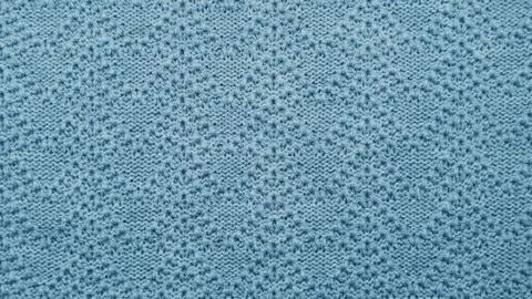 Blue knitted pattern fabric texture background. Stock Photos