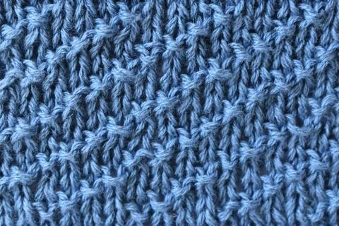 Blue knitted wool jersey with a diagonal stripe pattern. Stock Photos
