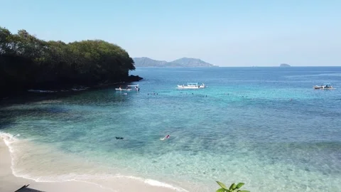 Blue Lagoon Beach Padangbai Bali With Snorkelers Boats and Turquoise Sea Stock Footage 339751671