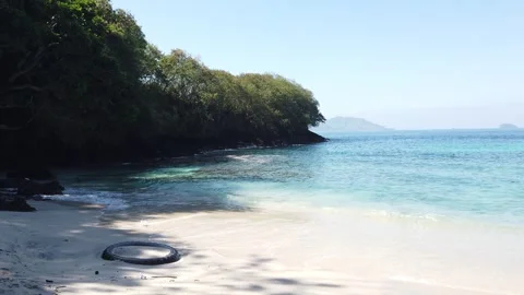 Blue Lagoon Beach Padangbai White Sand Turquoise Bay Rocky Cliffs and Distant Stock Footage 339751667