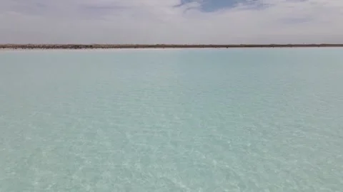 Blue lake with a beach made of salt , "Maldives" in Qinghai China Stock Footage 138912331