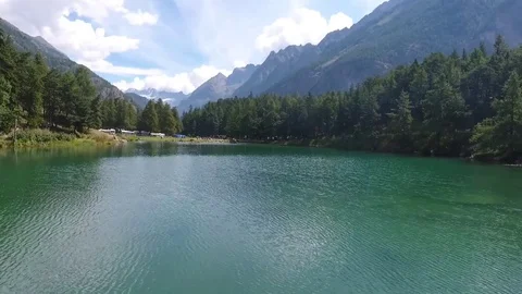 Blue lake at the edge of a campsite Stock Footage 79754256