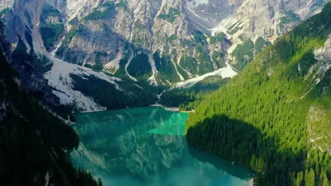 Blue lake, with the reflection of sunlight in the water. Landscape with forest a Stock Footage 137942636