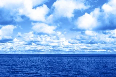 Blue lake surface with clouds. Stock Photos