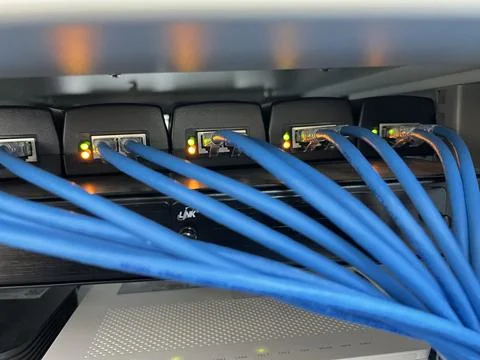 The blue lan cable jack is connected to the port in the Stock Photos
