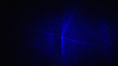 Blue laser beams create dramatic starburst light effect on dark background for 스톡 동영상 322095789