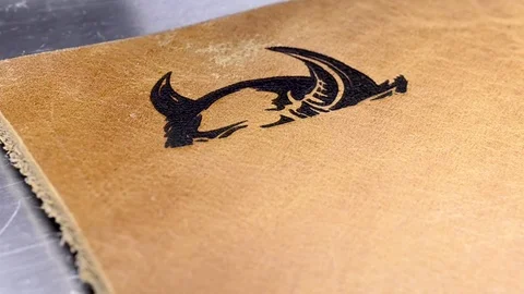 The blue laser cuts a pattern on a leather product. Close-up. Stock Footage 107943963