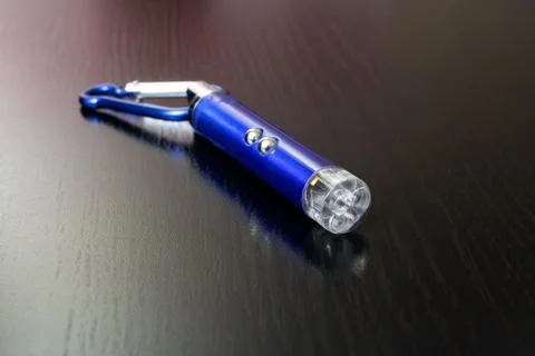 Blue laser pointer on a wooden background Stock Photos