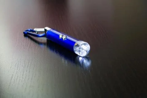 Blue laser pointer on a wooden background Stock Photos