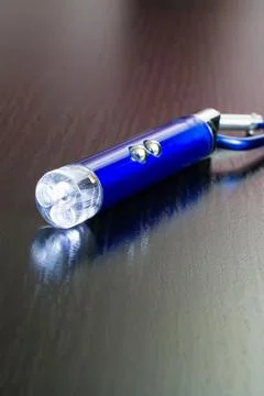 Blue laser pointer on a wooden background Stock Photos