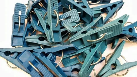 Blue laundry clips rotating on the white background, plastic clothes pins  Stock Footage 306201049