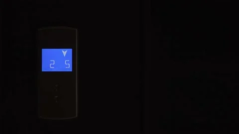 Blue LCD display on elevator shows down arrow and countdown from seven to two. Stock Footage 188268605
