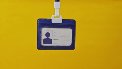 Blue leather ID badge template hanging against bright yellow background Stock Footage 337129529