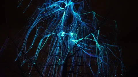 Blue led neon thread lights sway on branches of dark tree on black night Vídeos de archivo 253810306