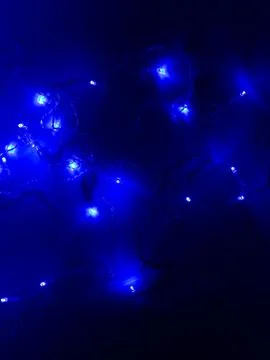Blue led string lights dark background Stock Photos