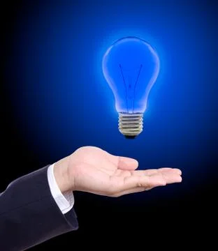 Blue light bulb on hand Stock Photos