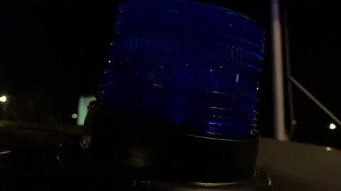 The blue light of the emergency vehicle flashes on the roof of the vehicle. A Stock Footage 183570968