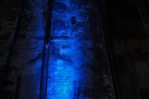 Blue light shining on and old industrial brick wall Stock Photos