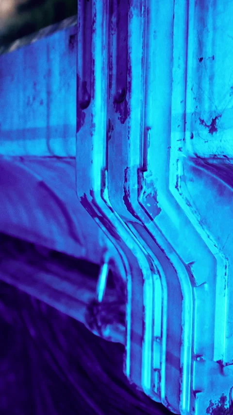 Blue lighting on metal structures creates industrial view at night Stock Footage 339394292