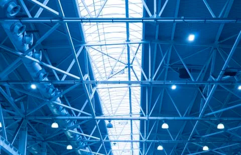 Blue Lights and ventilation system in long line on ceiling of the  industrial Stock Photos