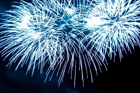 Blue lights of a bright firework in the night sky. 写真素材