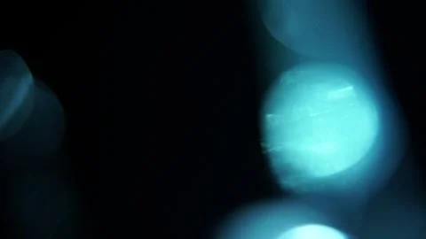 Blue lights shimmer softly against deep black void 動画素材 342947236
