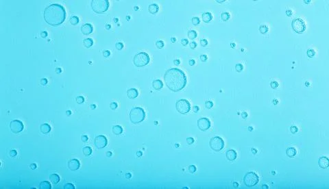 Blue liquid abstract background. Bubbles and textures of water on a blue Stock Photos
