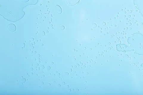 Blue liquid abstract background. Bubbles and textures of water on a blue back Stock Photos