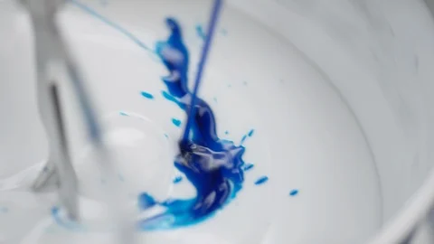 Blue liquid is added into lab blender to a white cream Video stock 100748834