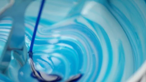 Blue liquid is added into lab blender to a white cream at the lab Stock Footage 100749147
