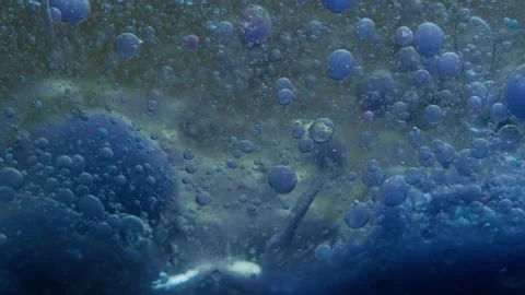 Blue liquid background. Macro shot of various air bubbles. Slow mo. Stock Footage 146742176