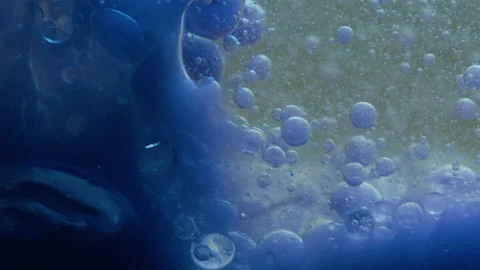 Blue liquid background. Macro shot of various air bubbles. Slow mo. Stock Footage 146743335