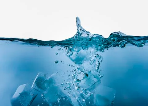 Blue liquid with bubbles and ice cubes in on white Stock Photos