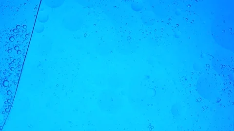 Blue liquid bubbles floating in abstract background Video stock 339369947
