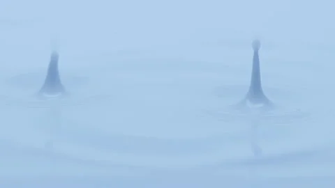 Blue liquid is dripped creating ripples ... | Stock Video | Pond5