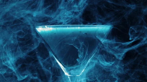 Blue liquid floating around a cocktail glass 스톡 동영상 130706573