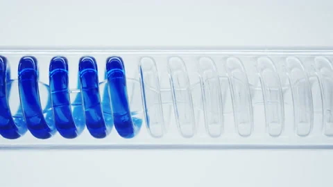 Blue liquid flows in a spiral into the flask. Stock Footage 144010972