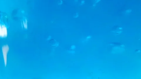 Blue liquid with glass pipette making bubbles Stock Footage 103573353