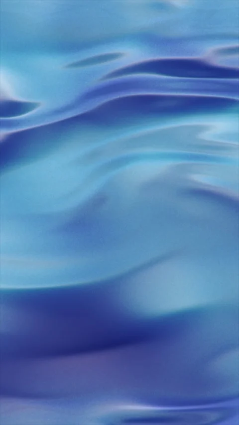 Blue liquid surface showing gentle waves and shimmering light. 库存影片 329851986