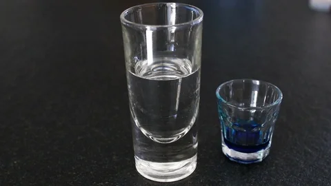 Blue liquid in a transparent glass Stock Footage 102709217