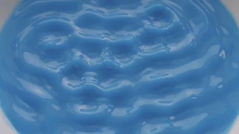Blue Liquid Vibrate on Sounds Waves in Slow Motion. Overhead Shot. Stock Footage 86421877