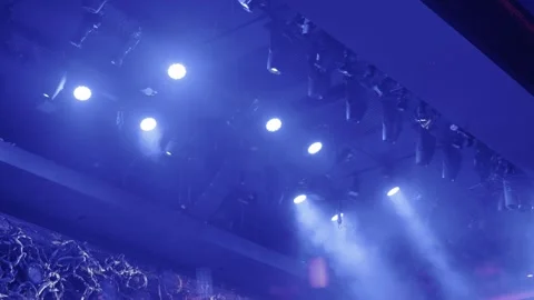 Blue lit stage with dramatic lighting and fog ambiance Stock Footage 321207399