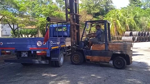 Blue Logistic Truck Loading Iron with Forklift Assistance Stock Footage 309306815