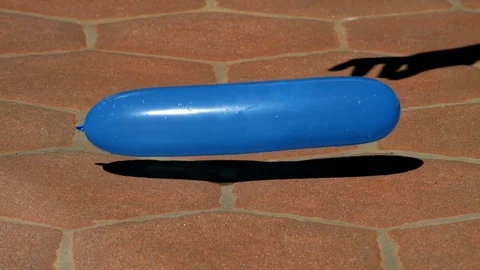 Blue Long Water Balloon Fall Bounces Explodes 2000fps Slow Motion Stock Footage 82552472