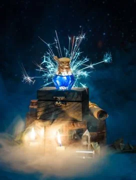Blue magic potion with sparkles and smoke on wooden box. Dark magic concept Stock Photos