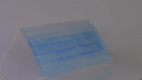 Blue mask in ray of light Stock Footage 129607299