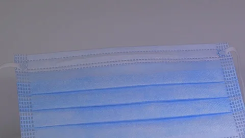 Blue mask, rotation on a white background Stock Footage 129607282