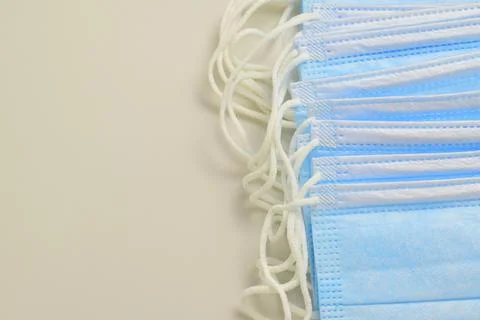 Blue masks with elastic bands to secure them behind the ears Stock Photos