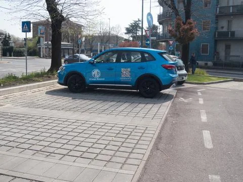 Blue MG EHS plug in hybrid SUV parked on interlocking pavement with Gruppo .. Stock Photos