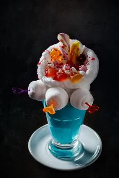 Blue milkshake with donuts on black background Stock Photos